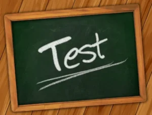 Chalkboard with the word “Test” written in white chalk, representing exams, assessments, or learning evaluation.